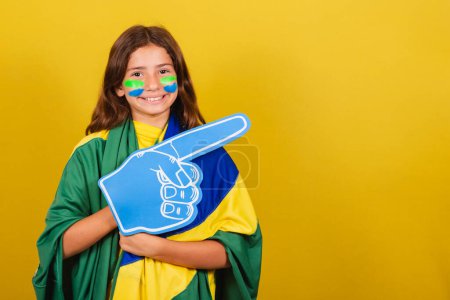 Photo for Brazilian caucasian child soccer fan pointing to the side, advertisement, promotion, advertisement. World Cup. Olympics. - Royalty Free Image