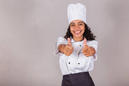 Photo for Young black brazilian woman, cook, masterchef. like sign, thumbs, approval - Royalty Free Image