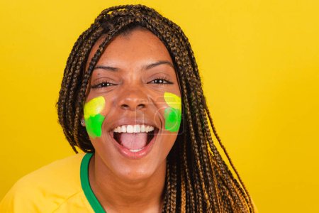 Photo for Black woman young brazilian soccer fan. close-up photo screaming goal. - Royalty Free Image