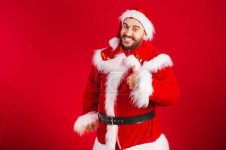 Photo for Brazilian man dressed in santa claus clothes, like sign - Royalty Free Image