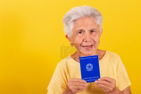 Photo for Old lady holding work card, retirement, older worker. Inclusion of the elderly in the labor market. - Royalty Free Image