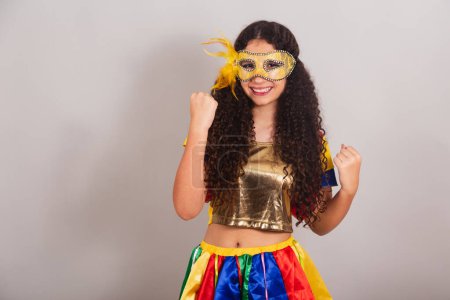 Photo for Young teen girl, brazilian, with frevo clothes, carnival. mask, celebrating. - Royalty Free Image