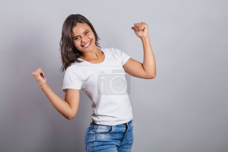 Photo for Beautiful brazilian woman. denim and white. smiling, dancing. optimistic, very happy. - Royalty Free Image