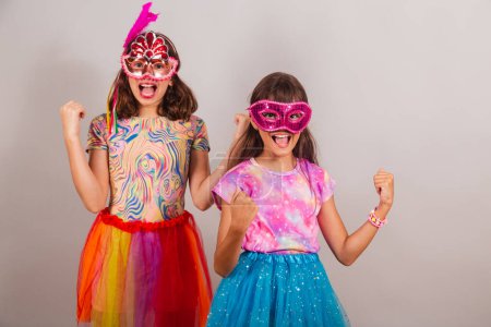 Photo for Two Brazilian children, girls, dressed in carnival clothes, celebrating. - Royalty Free Image