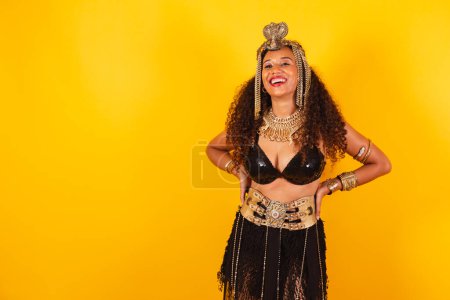 Photo for Horizontal, half body shot of beautiful black Brazilian woman in carnival clothes. hands on waist. - Royalty Free Image