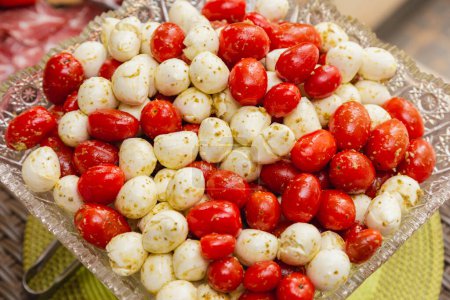 Photo for Party appetizer, cherry tomatoes and buffalo cheese in olive oil sauce. - Royalty Free Image