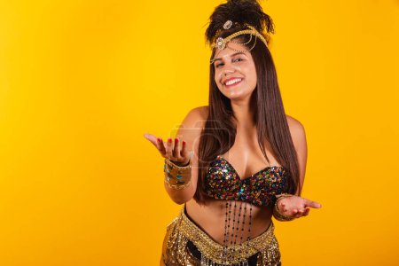 Téléchargez les photos : Belle femme brésilienne dans des vêtements de carnaval d'or invitant et appelant avec les mains - en image libre de droit
