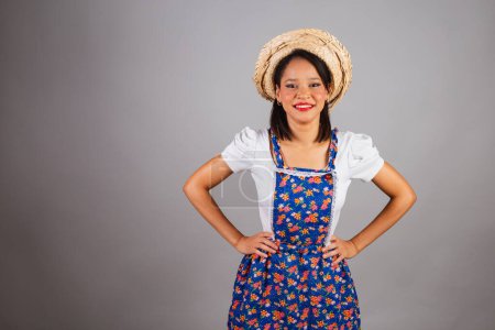Photo for Brazilian woman, northeastern, with June party clothes, straw hat. Hands on hips. - Royalty Free Image