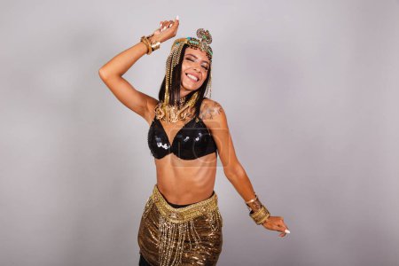 Photo for Horizontal, half body shot, beautiful Brazilian woman in carnival clothes. dancing. - Royalty Free Image