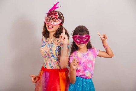 Photo for Two Brazilian children, girls, dressed in carnival clothes, dancing. - Royalty Free Image
