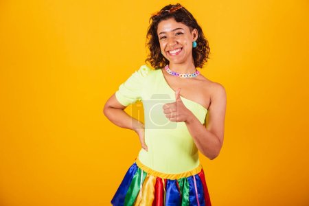 Foto de Hermosa chica brasileña afroamericana, con ropa de carnaval, como signo con las manos. - Imagen libre de derechos