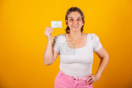 Photo for Adult Brazilian woman holding voter registration card - Royalty Free Image