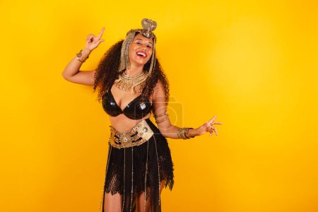 Photo for Horizontal, half body shot of beautiful black Brazilian woman in carnival clothes. dancing - Royalty Free Image