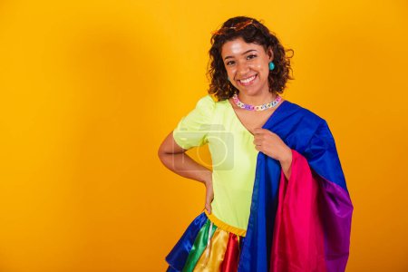 Photo for Beautiful afro american brazilian woman in carnival clothes holding bisexual lgbt flag. Bisexual pride. - Royalty Free Image