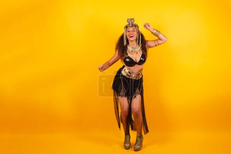 Photo for Horizontal photo, full body, Black Brazilian woman in carnival clothes. dancing. - Royalty Free Image