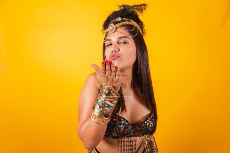 Photo for Beautiful Brazilian woman in golden carnival clothes, sending kiss. - Royalty Free Image