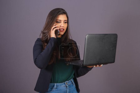 Photo for Horizontal photo. Beautiful Brazilian woman in casual clothes, black blazer jeans. with notebook and cell phone. - Royalty Free Image