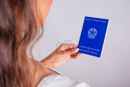 Photo for Hand holding work and social security card, Brazilian documents. - Royalty Free Image