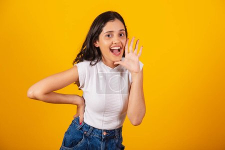 Photo for Beautiful brazilian woman arms sign shouting promotion. - Royalty Free Image