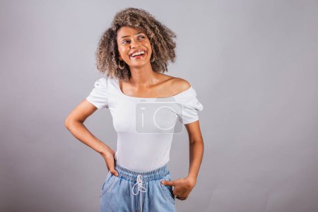 Photo for Beautiful black brazilian woman, in casual clothes, hands on her hips. - Royalty Free Image