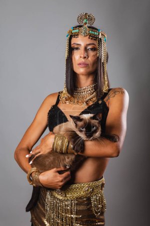 Photo for Vertical shot, half body, beautiful Brazilian woman in carnival clothes. posing for photo. And Cat - Royalty Free Image