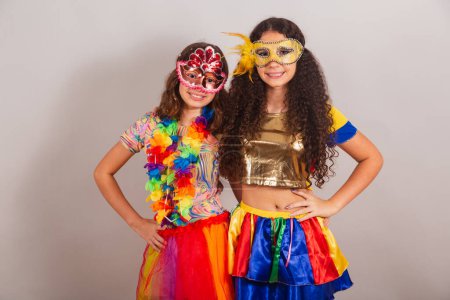 Photo for Brazilian girls friends, dressed in carnival clothes hugging each other. - Royalty Free Image