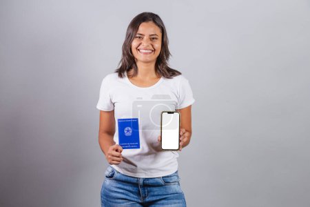 Photo for Brazilian woman, holding workbook and smart phone, Brazilian document for form work, human resources. - Royalty Free Image