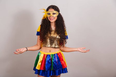 Photo for Young teen girl, brazilian, with frevo clothes, carnival. mascara, open arms welcome. - Royalty Free Image