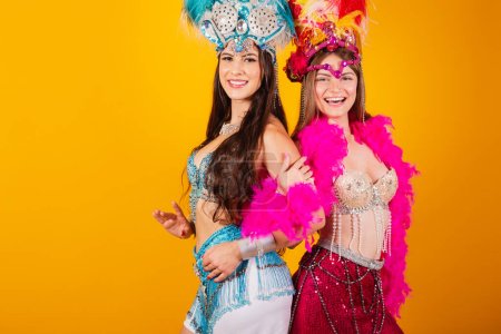 Téléchargez les photos : Deux amies brésiliennes avec des vêtements de reine de l'école de samba, carnaval. Couronne de plumes. - en image libre de droit