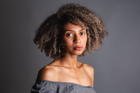 Photo for Beautiful black brazilian woman posing on grey studio background - Royalty Free Image