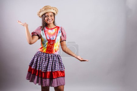 Brazilian woman wearing country clothes, So Joo party, Junina party. Open arms welcome. welcoming