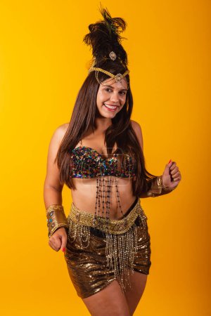 Photo for Beautiful Brazilian woman in golden carnival clothes, dancing, enjoying and partying. vertical photo - Royalty Free Image