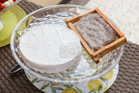 Photo for Brie cheese served with honeycomb, traditional cheese served with honey at social events. - Royalty Free Image