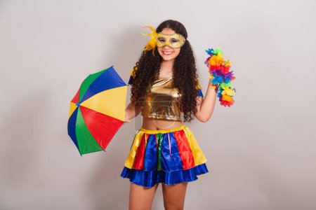 Photo for Young teen girl, brazilian, with frevo clothes, carnival. with frevo umbrella. flower necklace. - Royalty Free Image