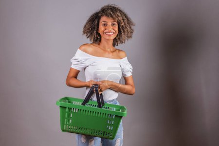 Téléchargez les photos : Belle femme brésilienne noire tenant le panier du marché, shopping, publicité, discount, promotion. - en image libre de droit
