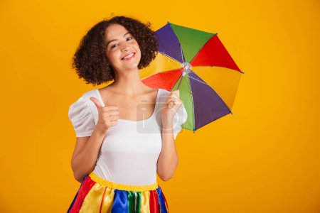 Photo for Beautiful Brazilian woman, dressed in carnival clothes, colorful skirt and white shirt. like, positive sign. - Royalty Free Image