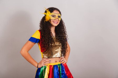Photo for Young teen girl, brazilian, with frevo clothes, carnival. Mask, hands on hips. posing for photo. - Royalty Free Image