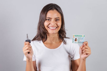 Photo for Brazilian woman, with driver's license, license to drive. Brazilian document. Car key, new car. - Royalty Free Image