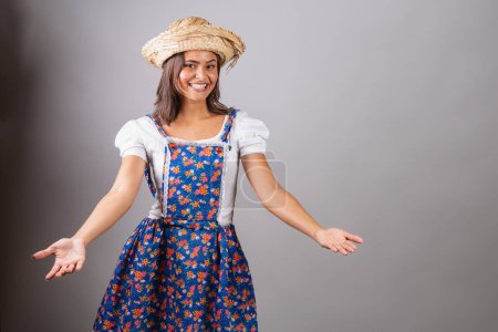 Photo for Brazilian woman wearing country clothes, So Joo party, Junina party. With open arms, welcome. - Royalty Free Image