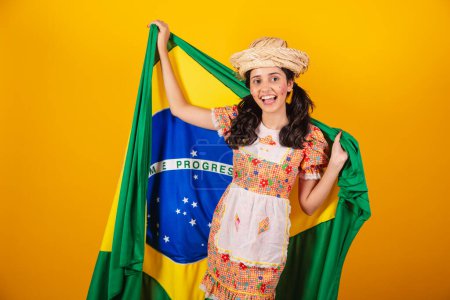 Photo for Brazilian woman, with clothes of festa junina, with flag of brazil - Royalty Free Image