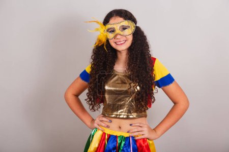Photo for Young teen girl, brazilian, with frevo clothes, carnival. Mask, hands on hips. posing for photo. - Royalty Free Image