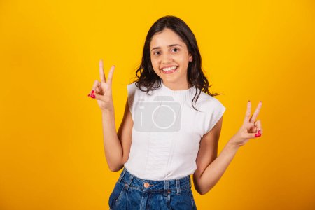 Photo for Beautiful brazilian woman peace and love sign with fingers. - Royalty Free Image