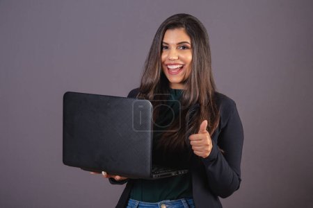 Photo for Horizontal photo. Beautiful Brazilian woman in casual clothes, black blazer jeans. with notebook. - Royalty Free Image