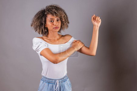 Photo for Brazilian black woman, with high clenched fist, feminist position, struggle, female empowerment. - Royalty Free Image