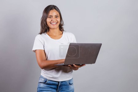 Photo for Brazilian woman, holding notebook. Connected, internet, web, developer. - Royalty Free Image