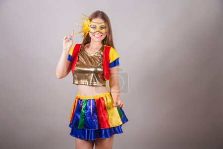 Photo for Brazilian blonde woman, dressed in frevo clothes, carnival mask, dancing. - Royalty Free Image