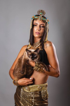 Photo for Vertical shot, half body, beautiful Brazilian woman in carnival clothes. posing for photo. And Cat - Royalty Free Image