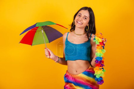 Photo for Beautiful brazilian woman in carnival clothes, holding colorful umbrella and flower necklace. - Royalty Free Image