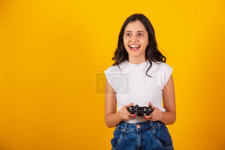Photo for Beautiful brazilian woman holding video game controller. playing game. - Royalty Free Image