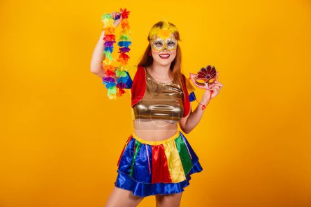 Téléchargez les photos : Rousse brésilienne, avec des vêtements de carnaval, frevo, et parasol coloré. portant un mascara et un collier de fleurs. - en image libre de droit